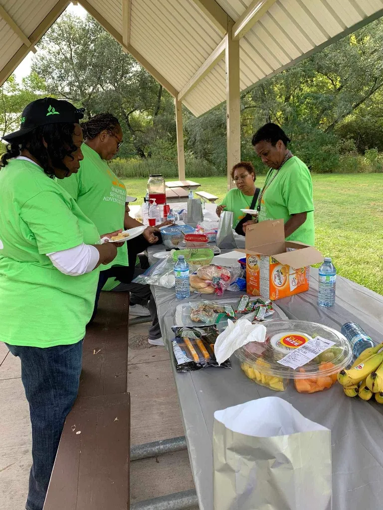 Serving lunch: Hands that prepare and share.