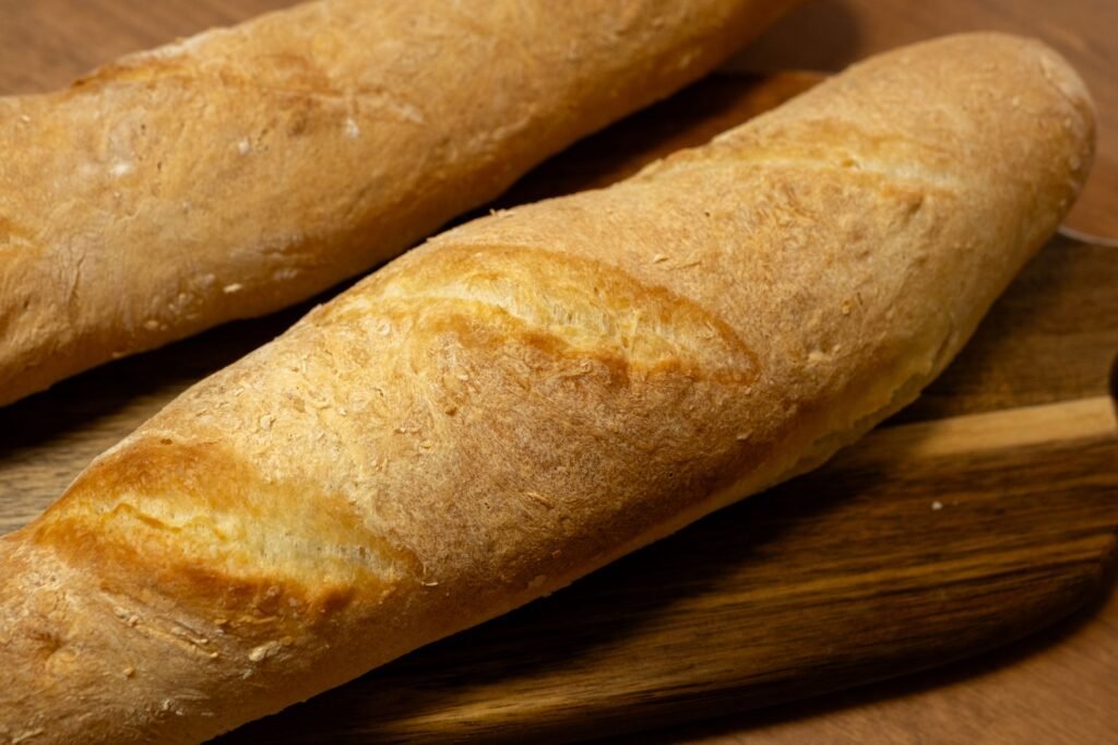 Golden loaves of bread on a wooden board