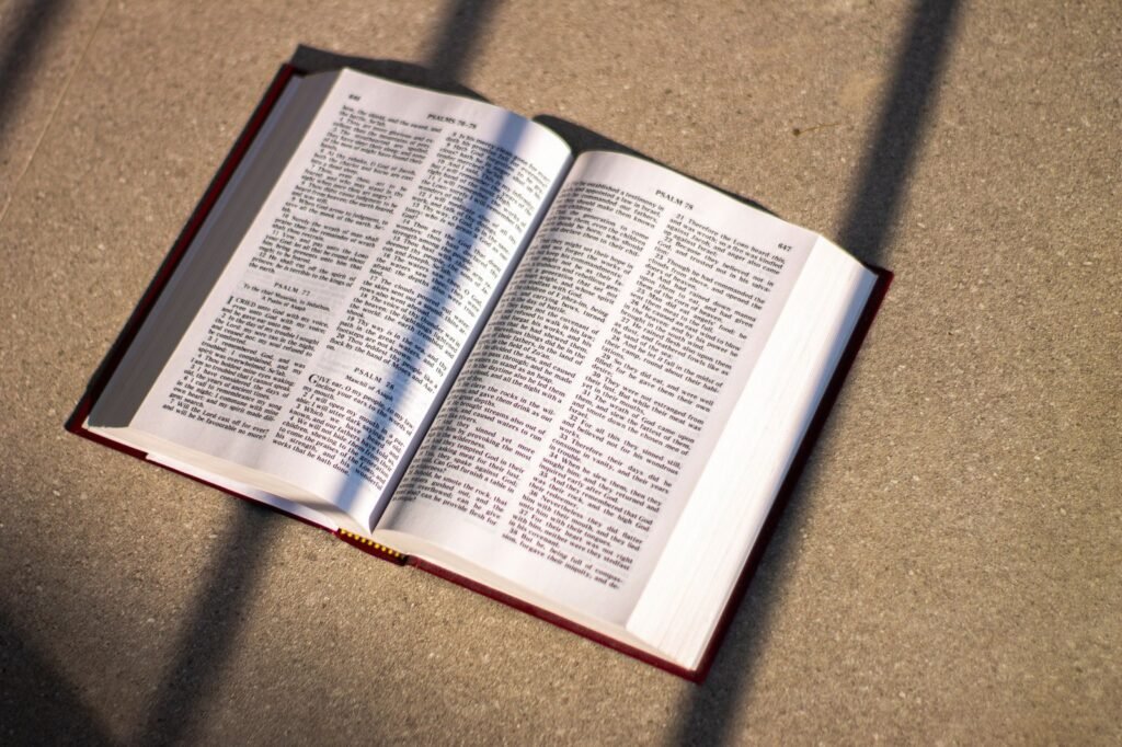 An open Bible with morning light falling across the pages
