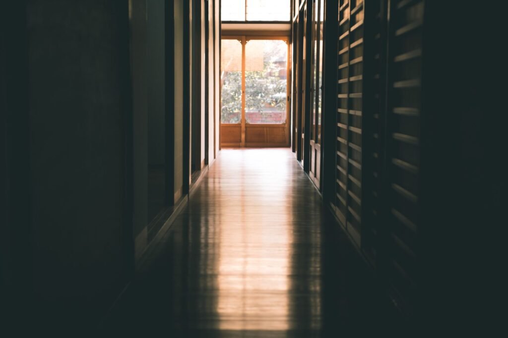 A corridor opening to bright daylight