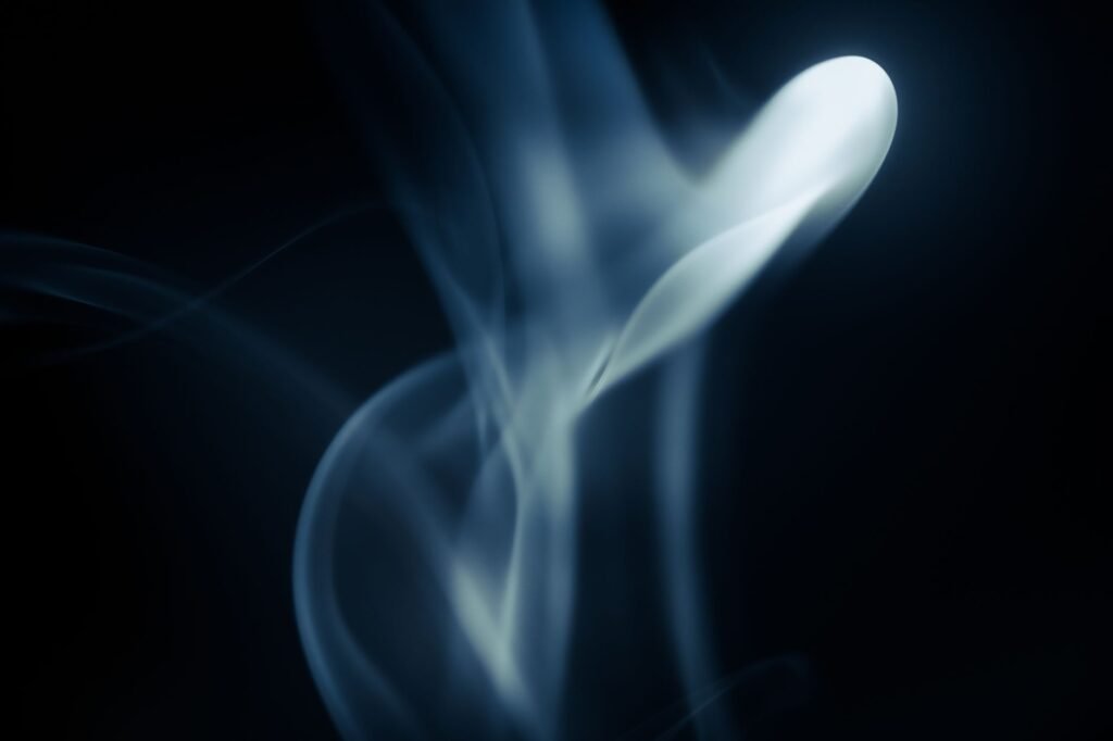 A single ribbon of fragrant smoke rising in the dark